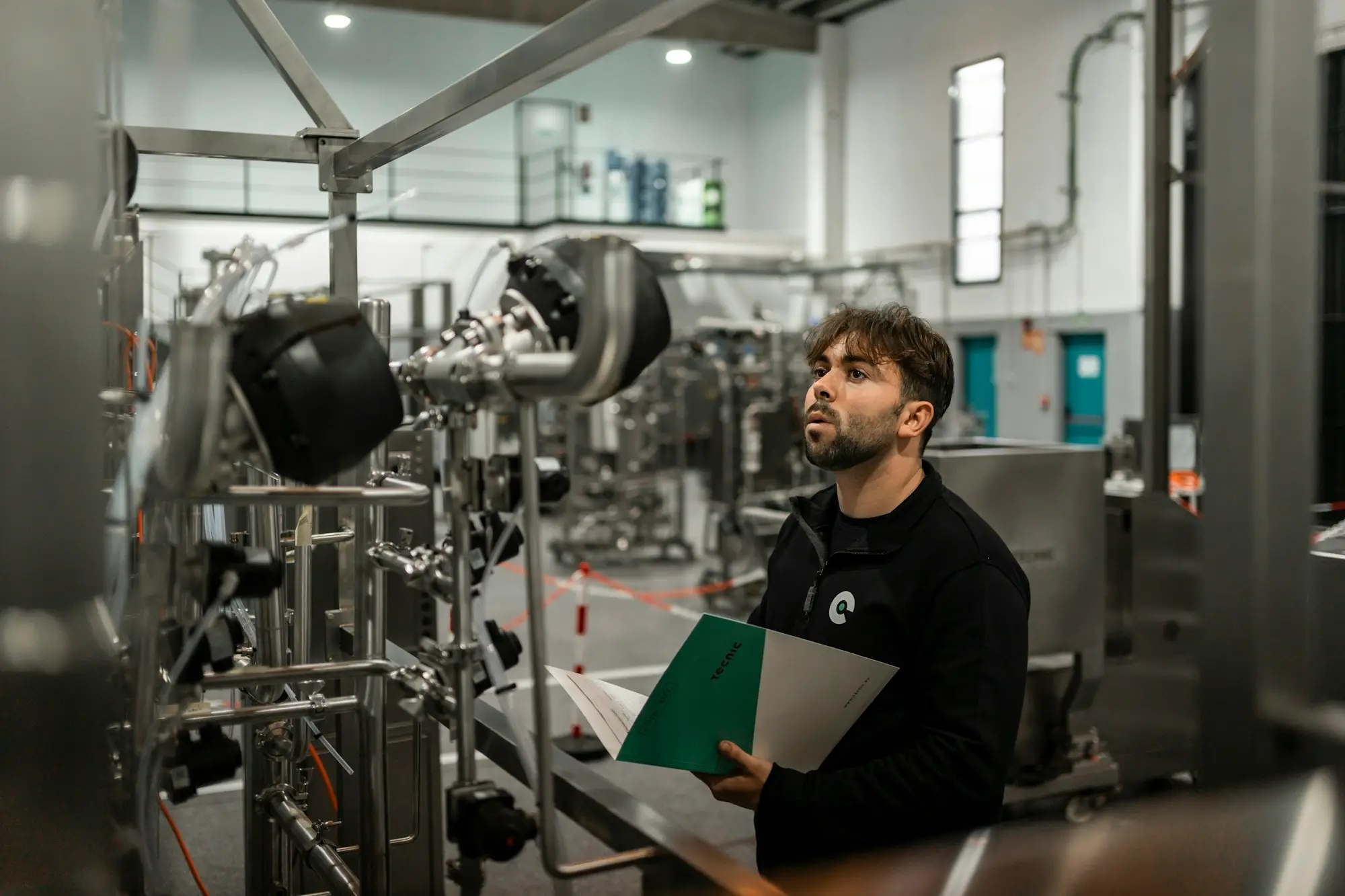 Man inspecting machinery in a factory