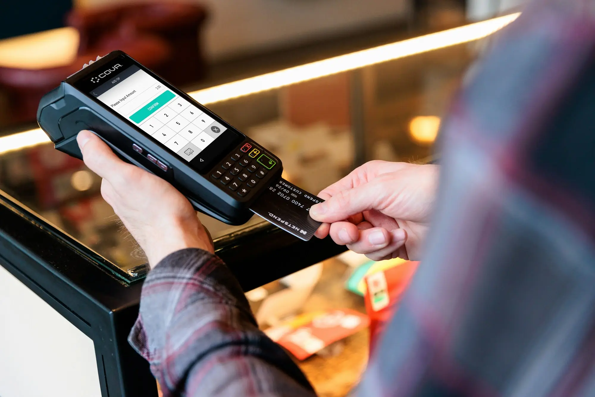Customer paying with a card at a shop terminal